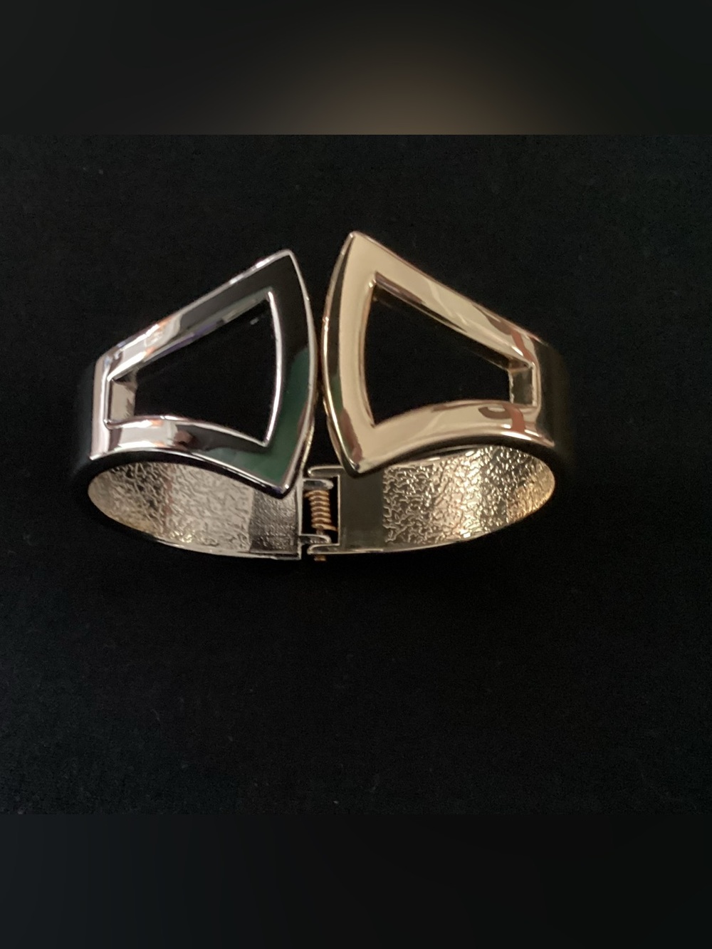 Bracelet, half silver, half gold coloured.